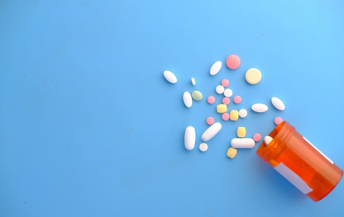 Pills spilling out of a pill bottle, symbolizing healthcare and pharmaceutical issues relevant to False Claims Act whistleblower cases and health care fraud litigation