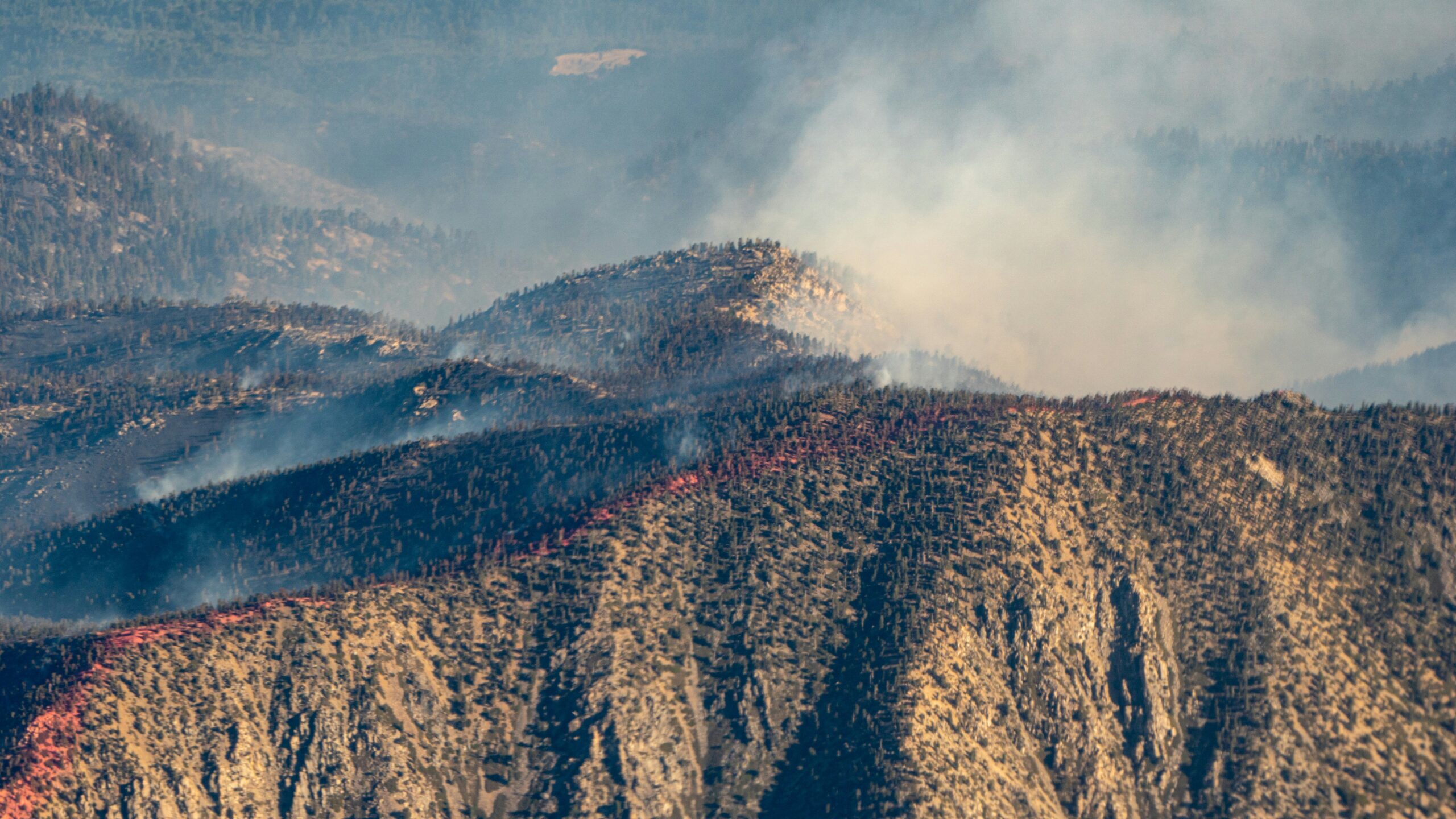 Mountain with smoke and firefighting efforts